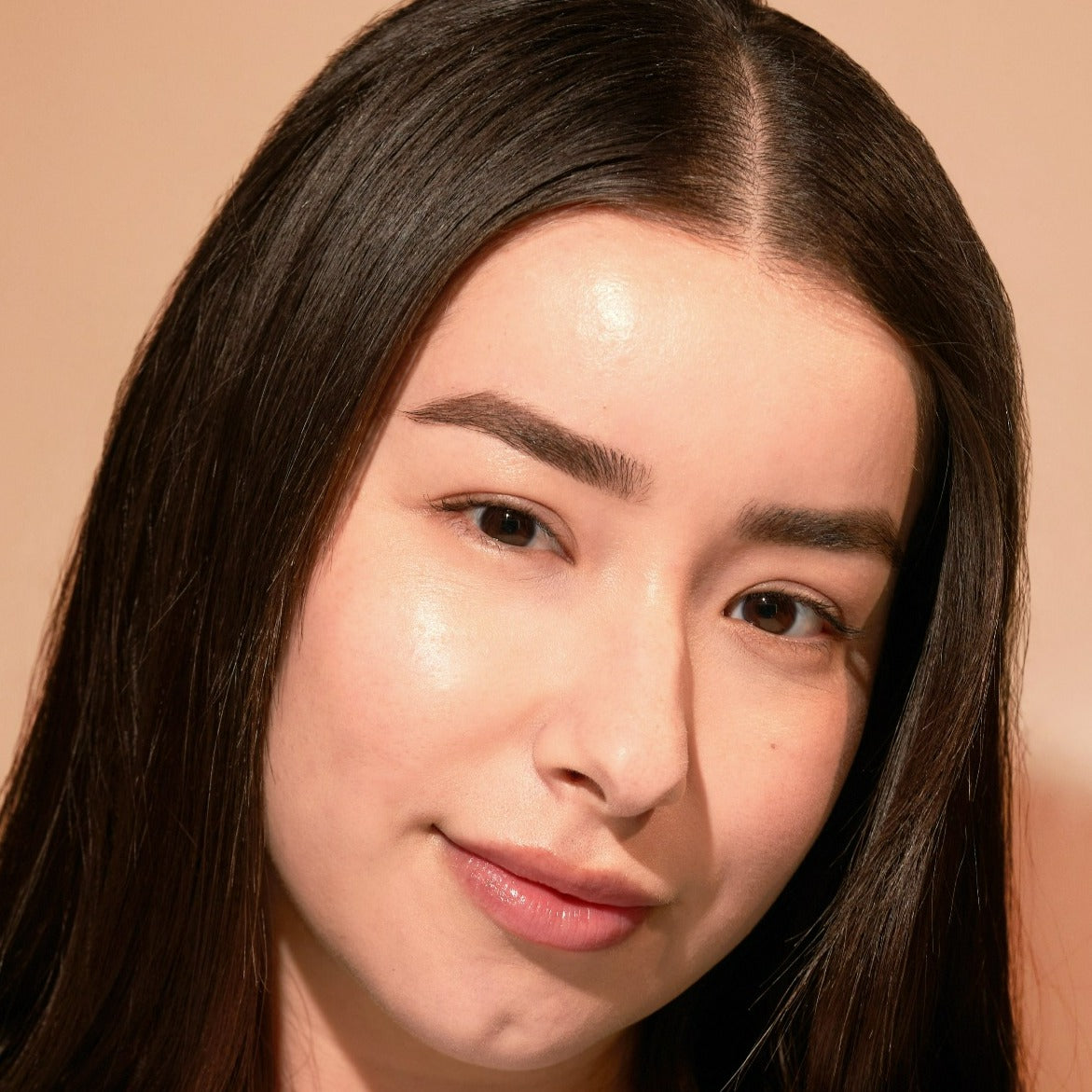 Portrait of a woman with long dark hair and subtle makeup.