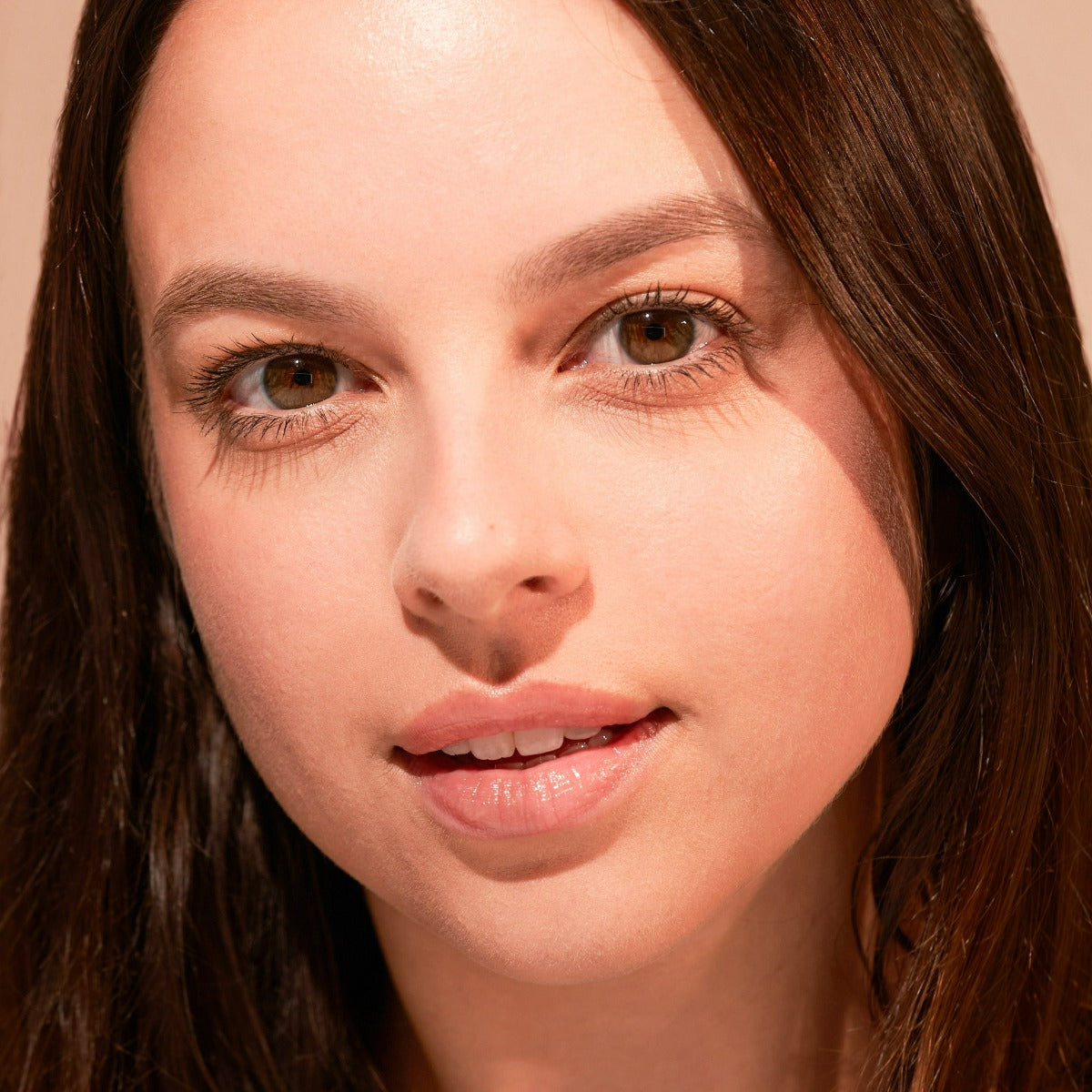 Portrait of a person with long dark hair and brown eyes.