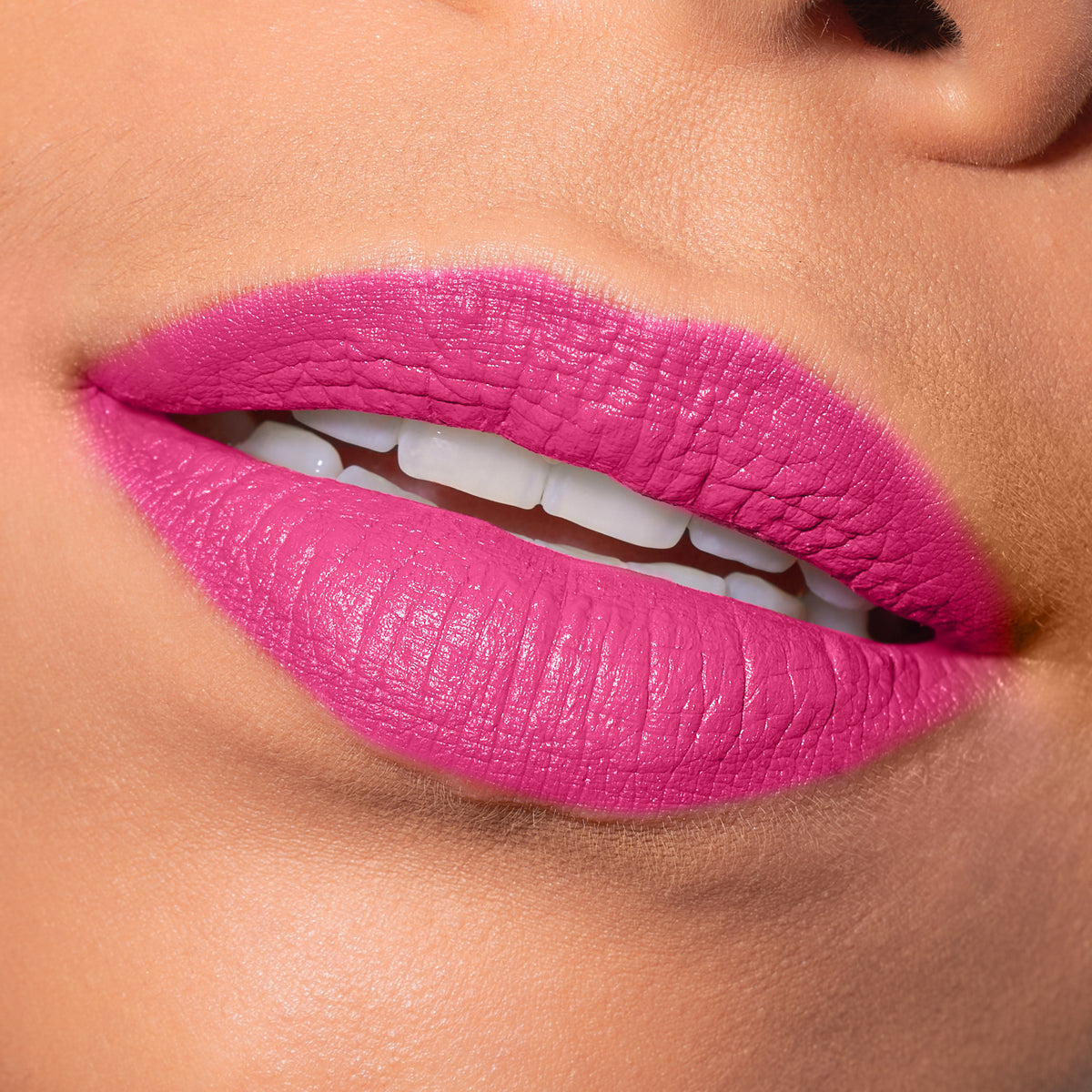 Close-up of lips with bright pink lipstick